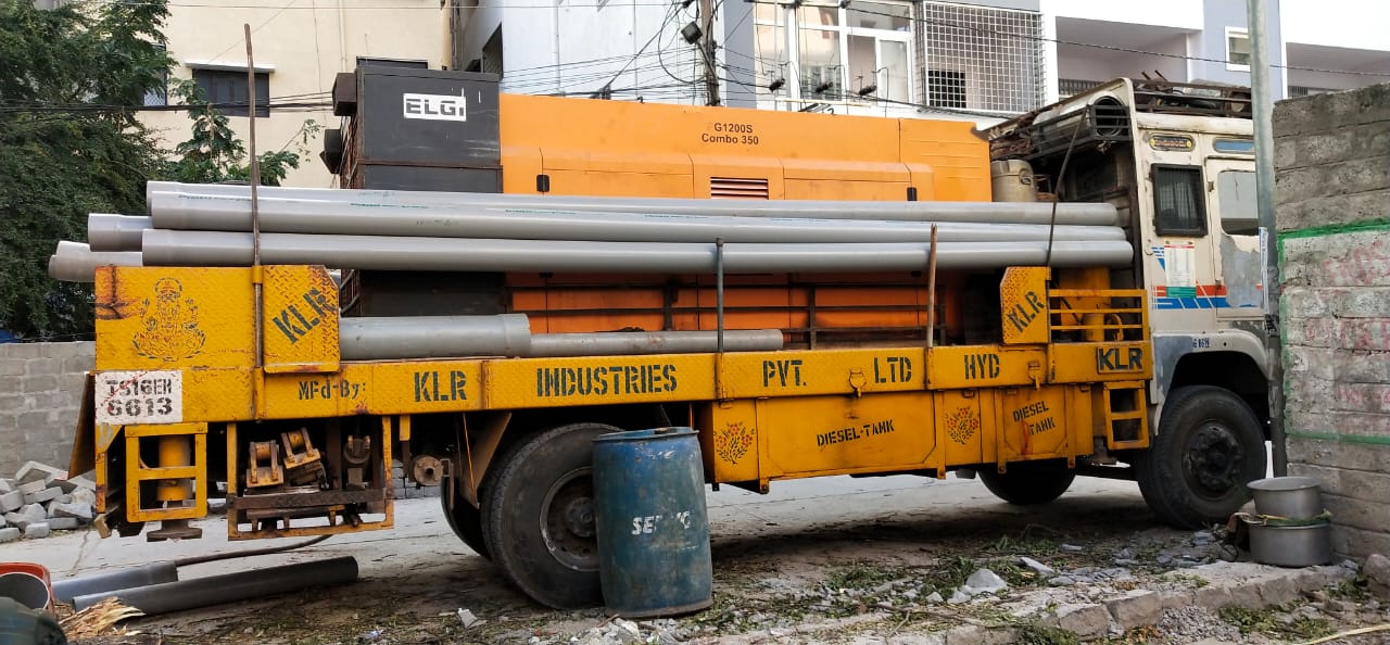 KLR rig with casing pipes and air compressor unit